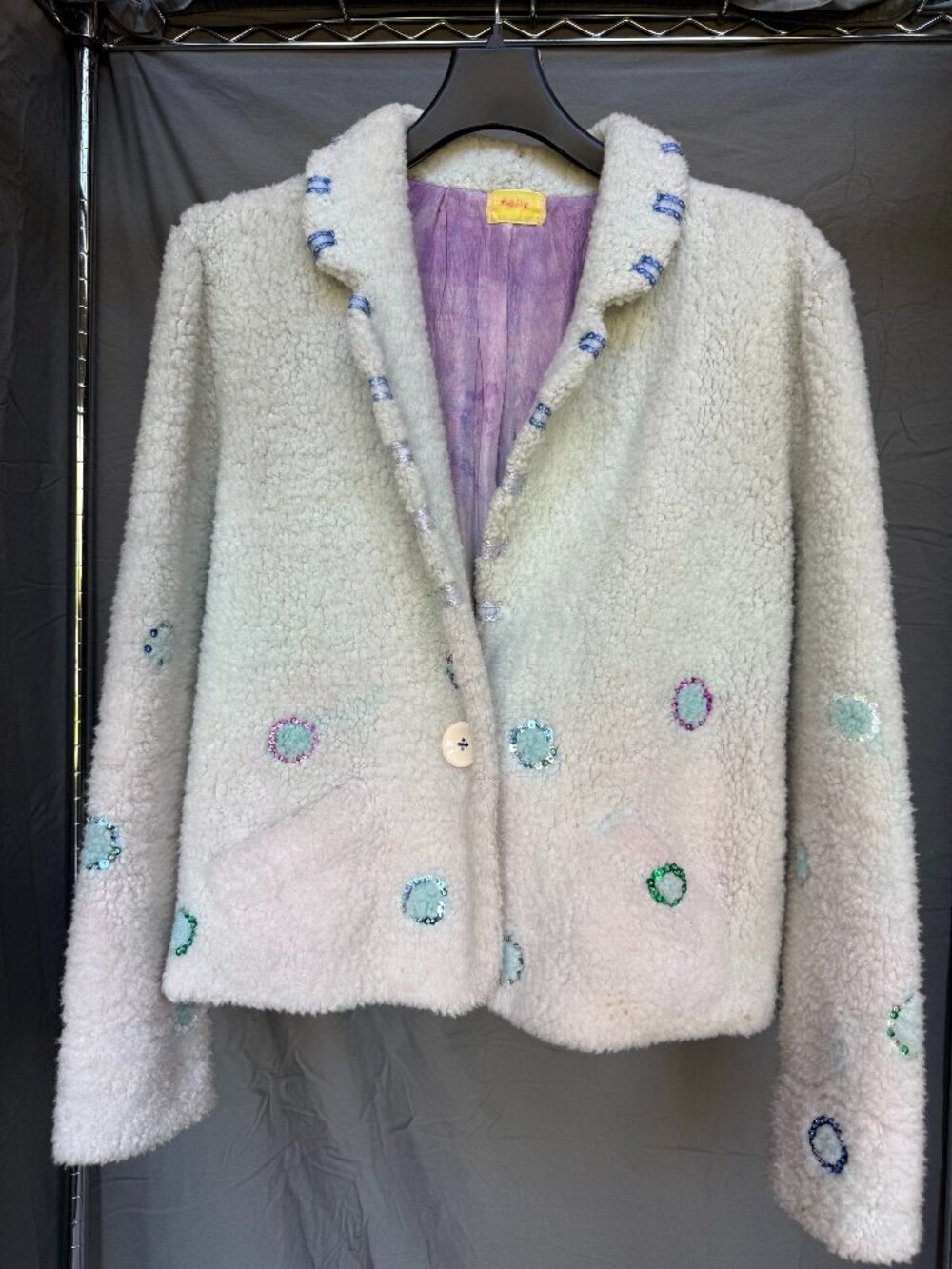 Fuzzy jacket with sequins ornamentation